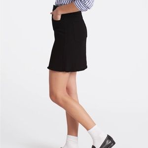 JUST BLACK black denim mini skirt. A wardrobe staple to wear with everything!